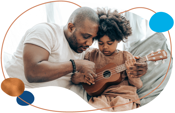 dad teaching daughter to play guitar